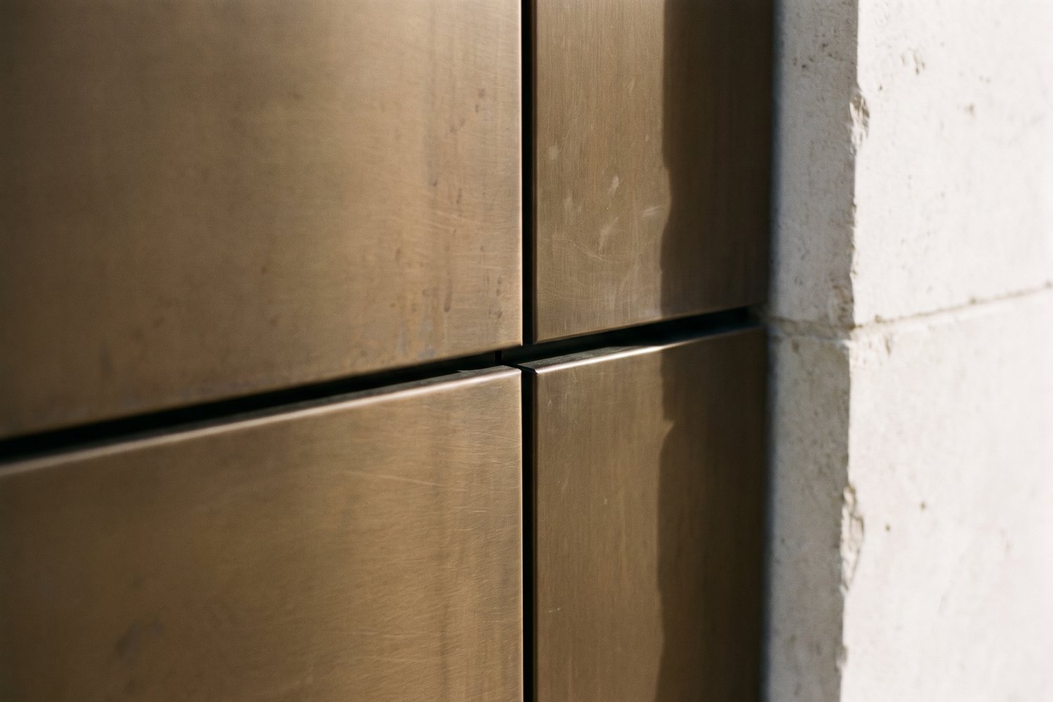 Bronze cladding panel run with fine joint lines