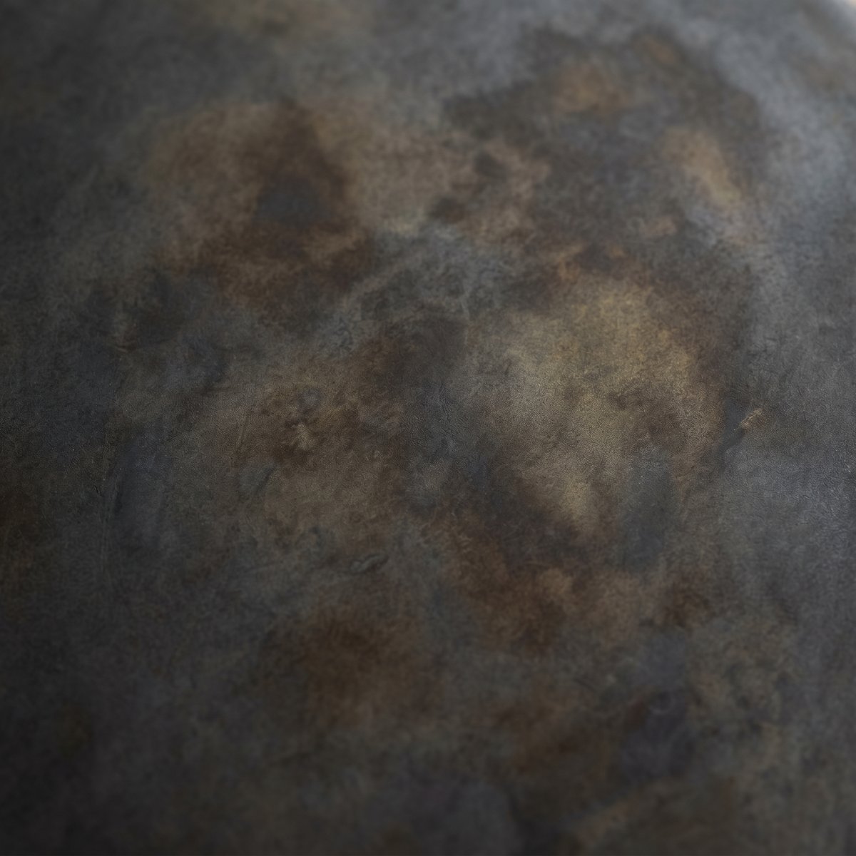 Blackened steel finish texture close-up, charcoal to gunmetal