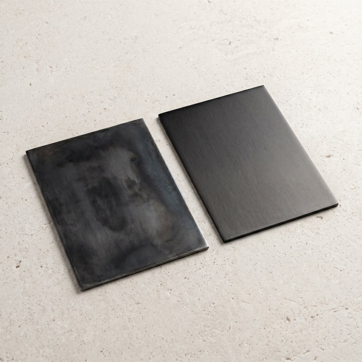 Blackened steel and black PVD sample plates compared