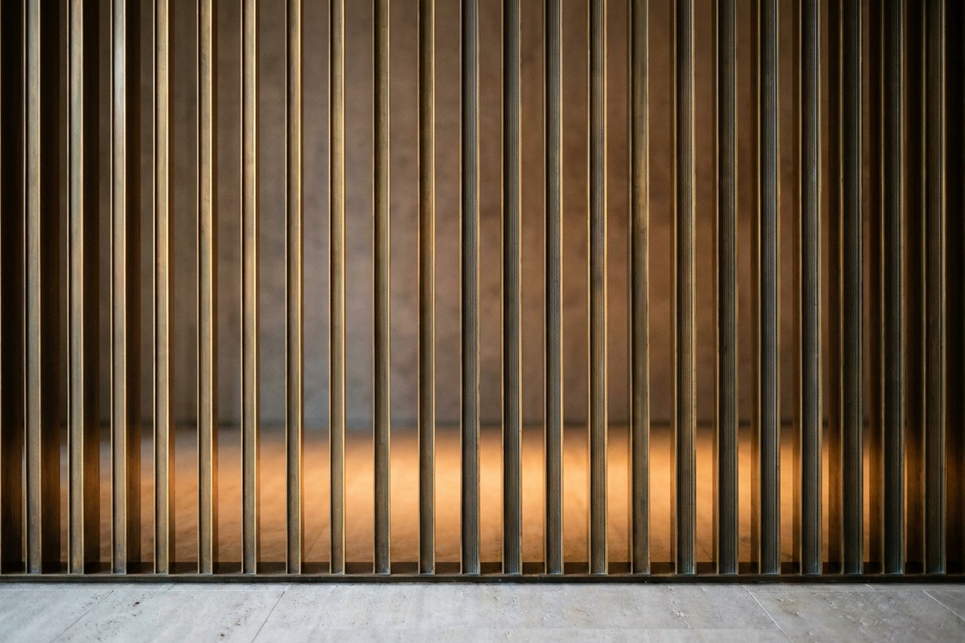 Bronze fin screen partition in a hotel lounge