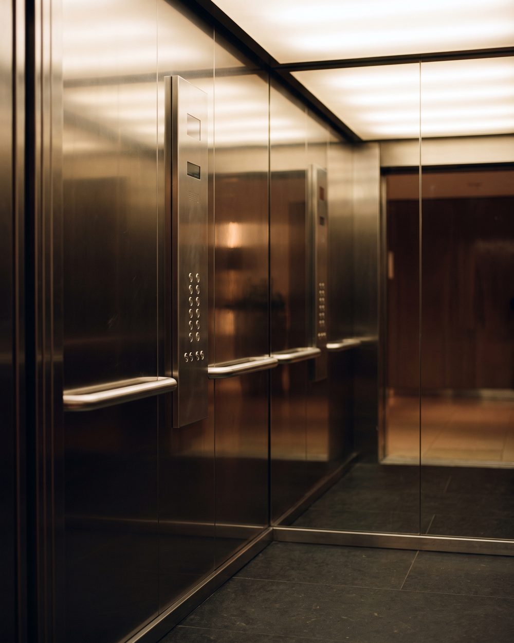Mirror stainless lift interior as a calm reflective plane