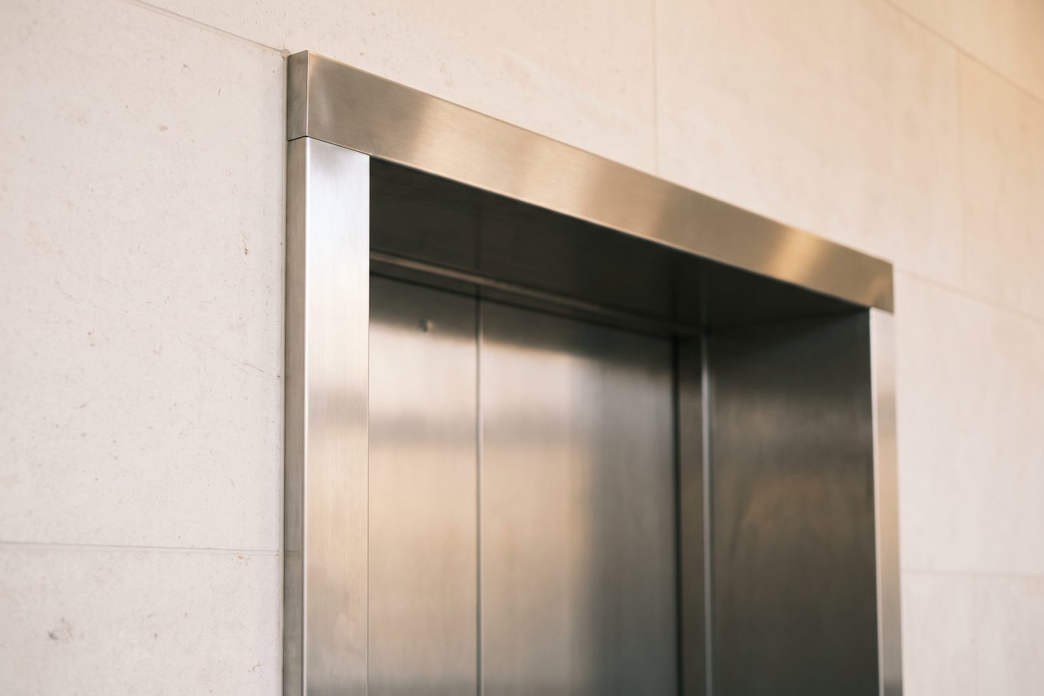 Brushed stainless lift entrance surround as a flat frame