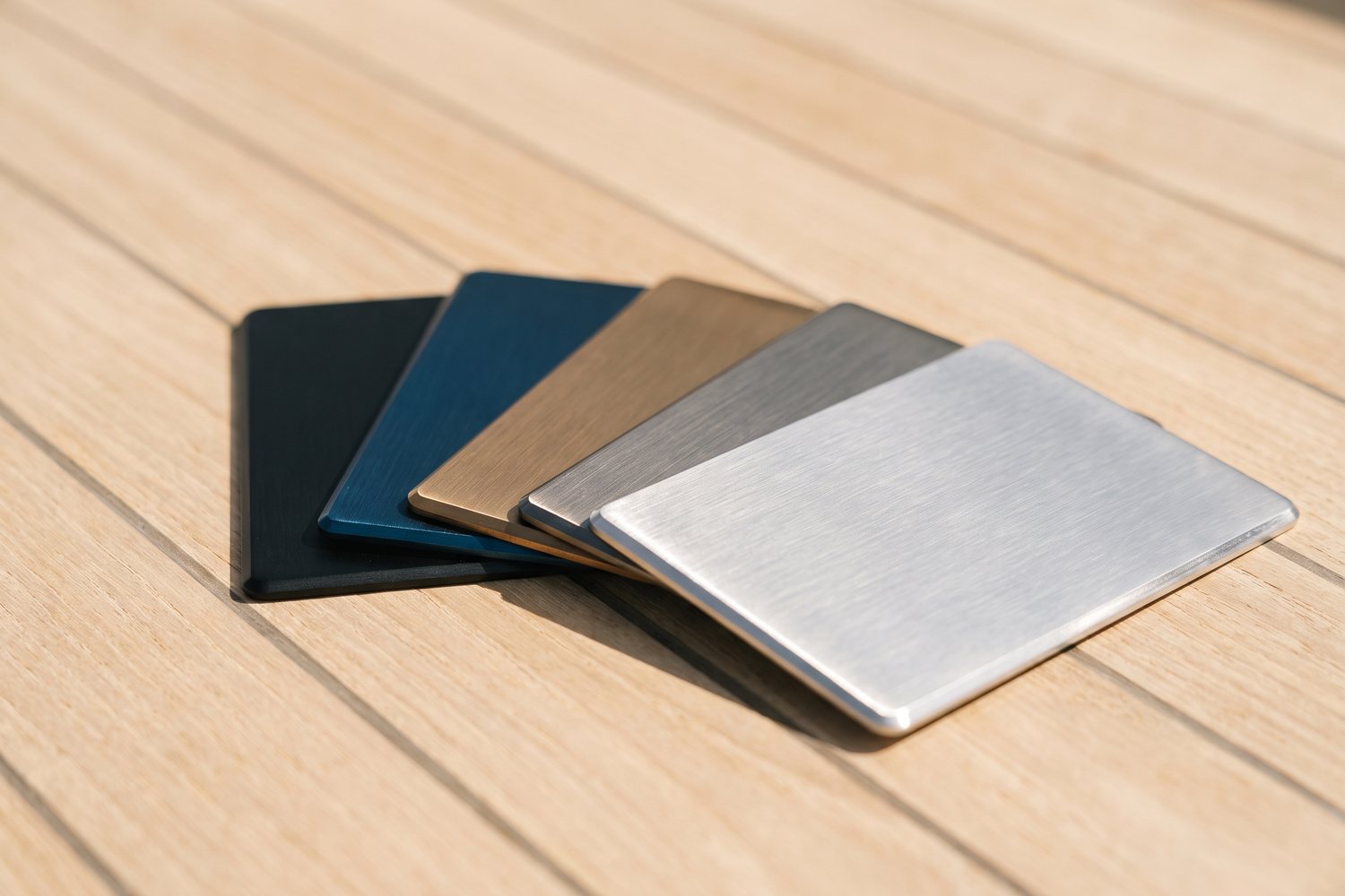 Marine grade stainless and PVD coloured sample plates on teak