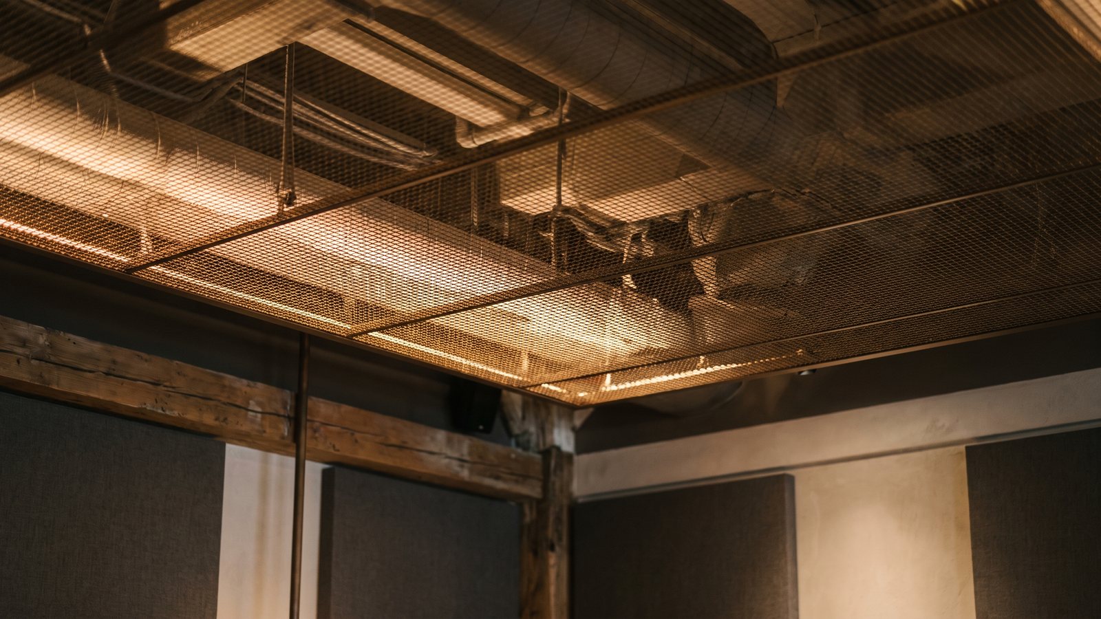 Metal mesh ceiling soffit with light behind