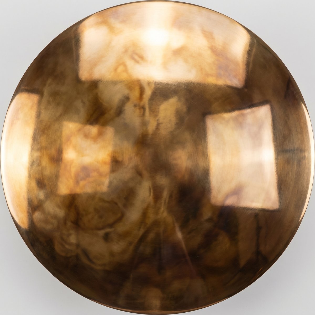 Patinated bronze surface in warm brown and chocolate tones