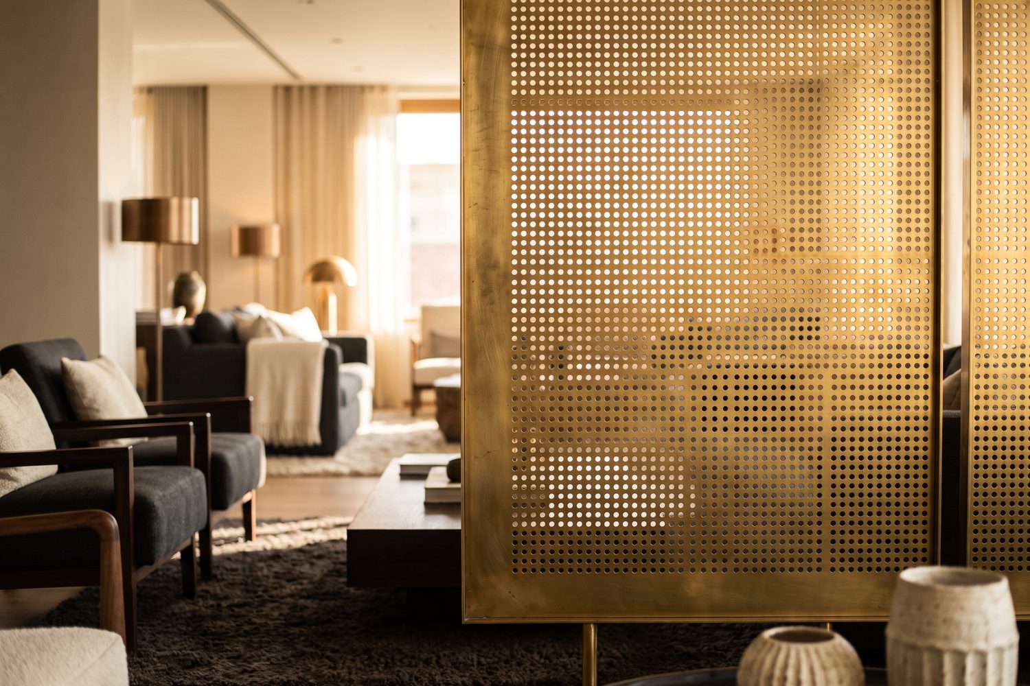 Perforated brass screen as a flat plane dividing an interior
